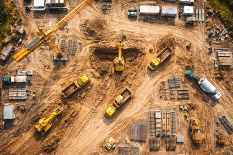 Image of an aerial view of an active construction site showing the advantages of drones for job site monitoring